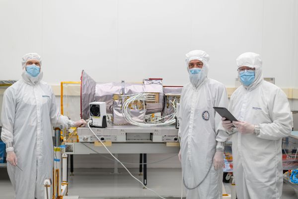 Hardware and staff inside a cleanroom.