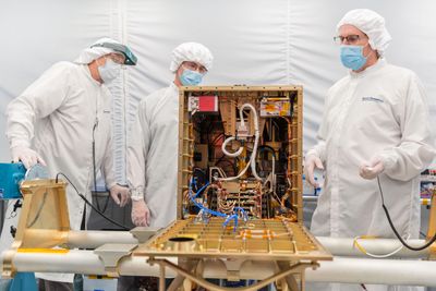 Hardware and staff inside a cleanroom.