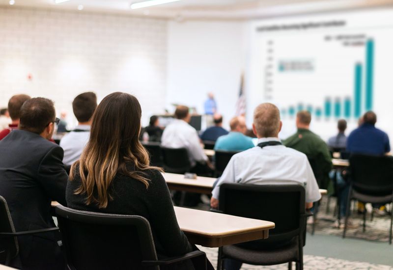 An audience listening to a speaker.