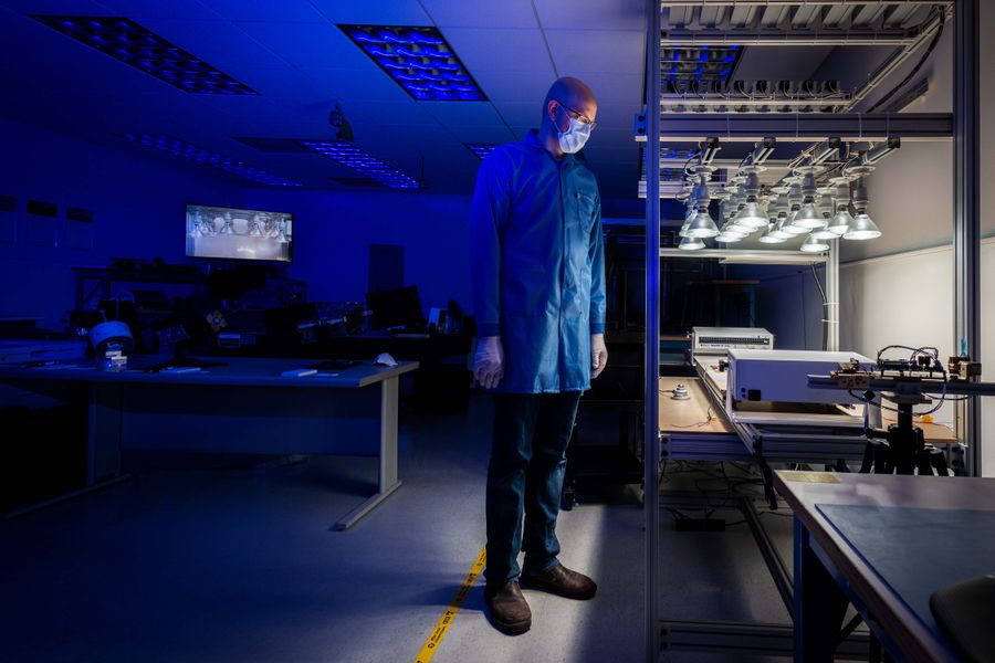 A person standing in SDL's Small Satellite Verification and Validation Lab.