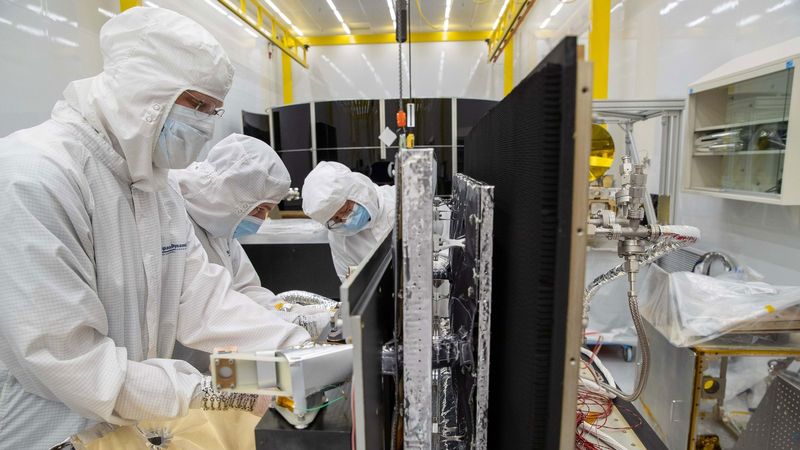 Engineers in suits working on a machine