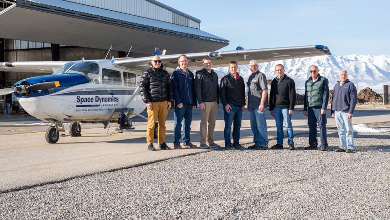 Staff in front of an aircraft at SDL's hangar.