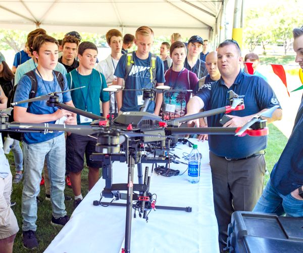 People looking at a drone.