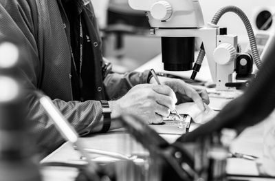 Close-up of a person working on a circuit board.