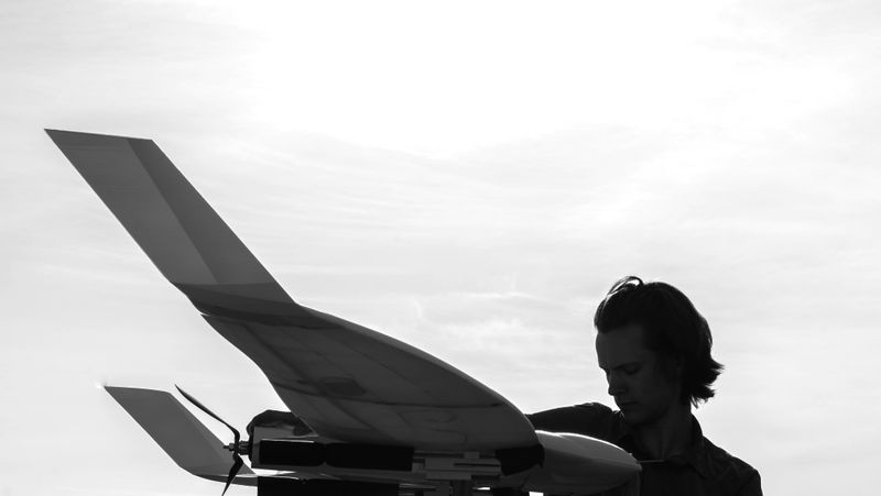 Silhouette of a person holding a UAS.