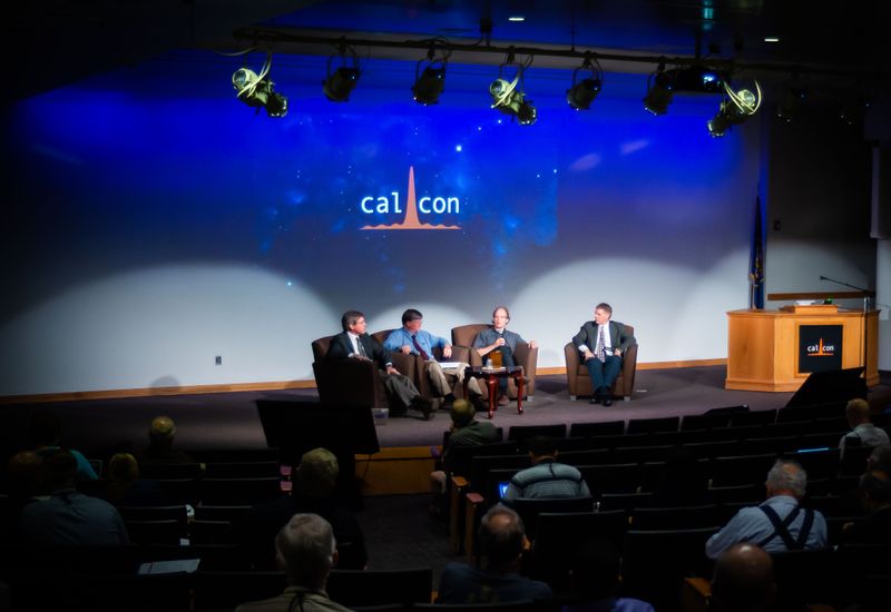 A discussion panel sitting on a stage.