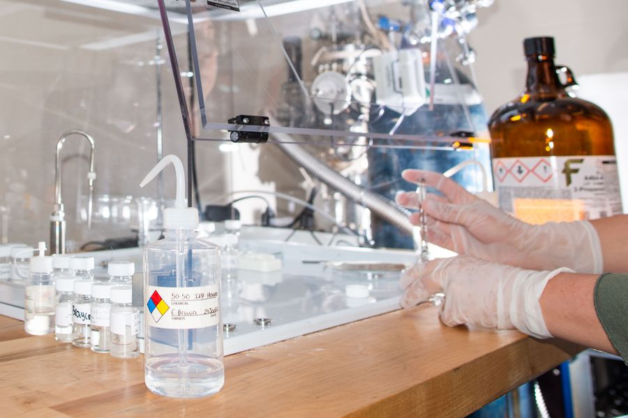 A close-up of a person performing chemical analysis.