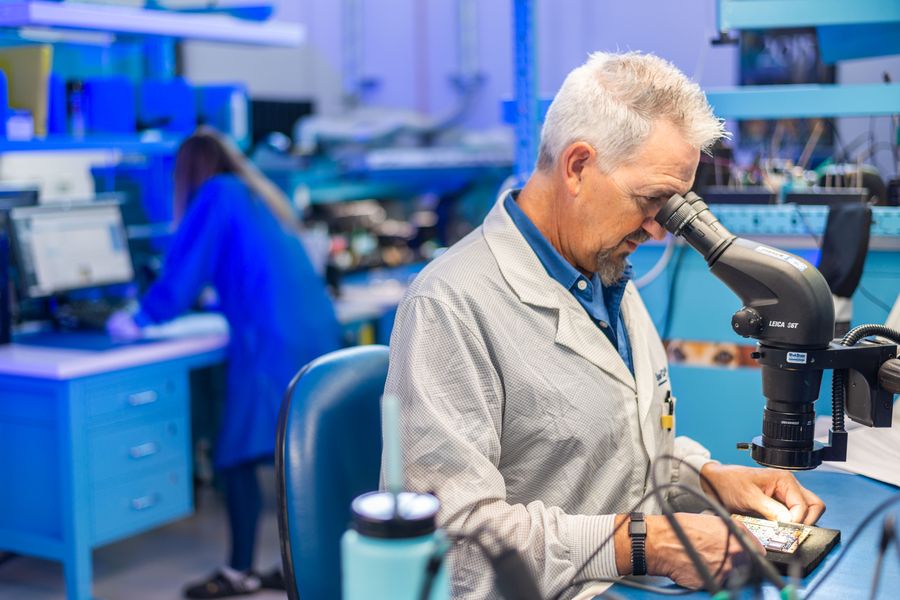 Electronics technician performing an inspection.