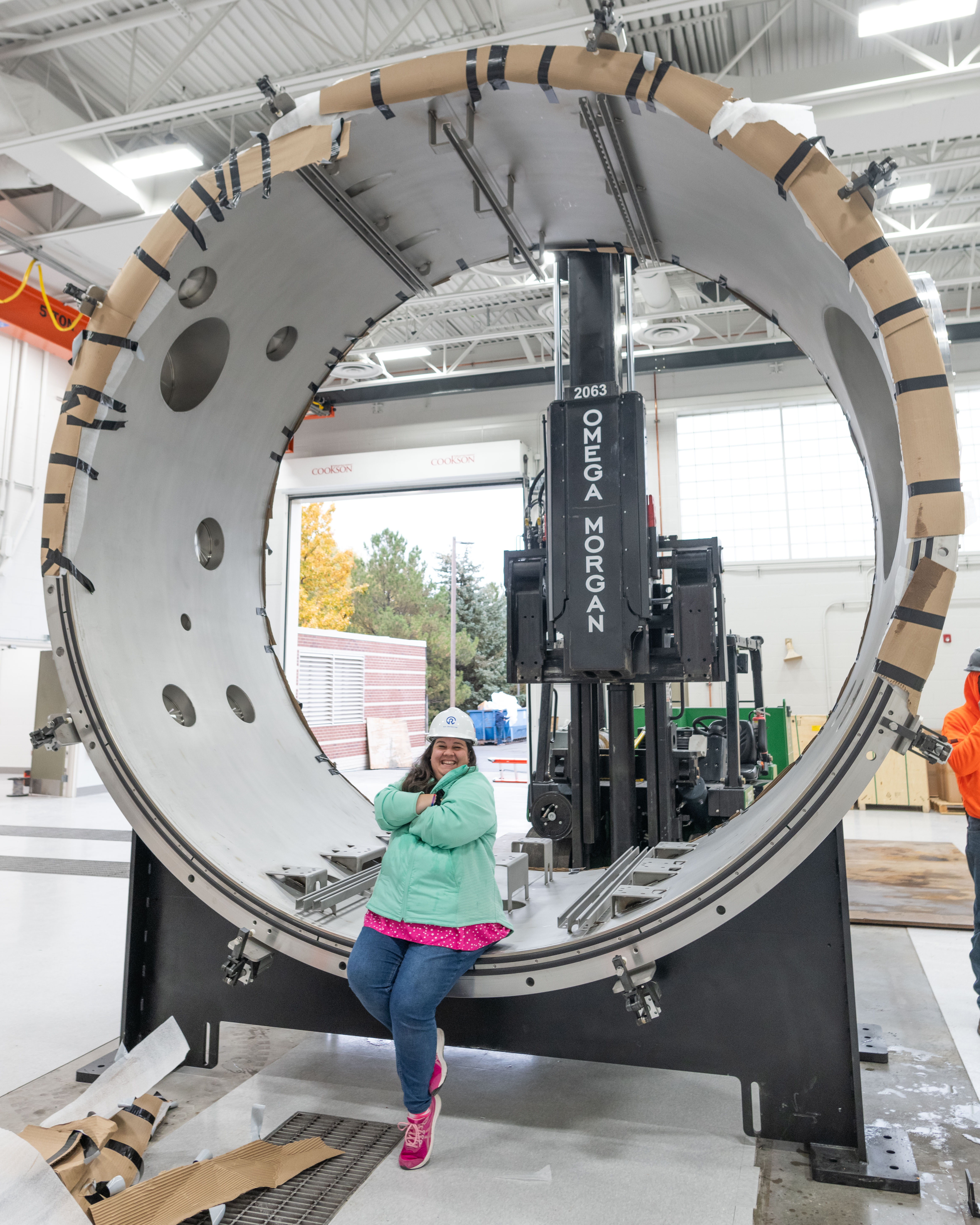 SDL's Brittany Woytko in front of a thermal vacuum chamber.